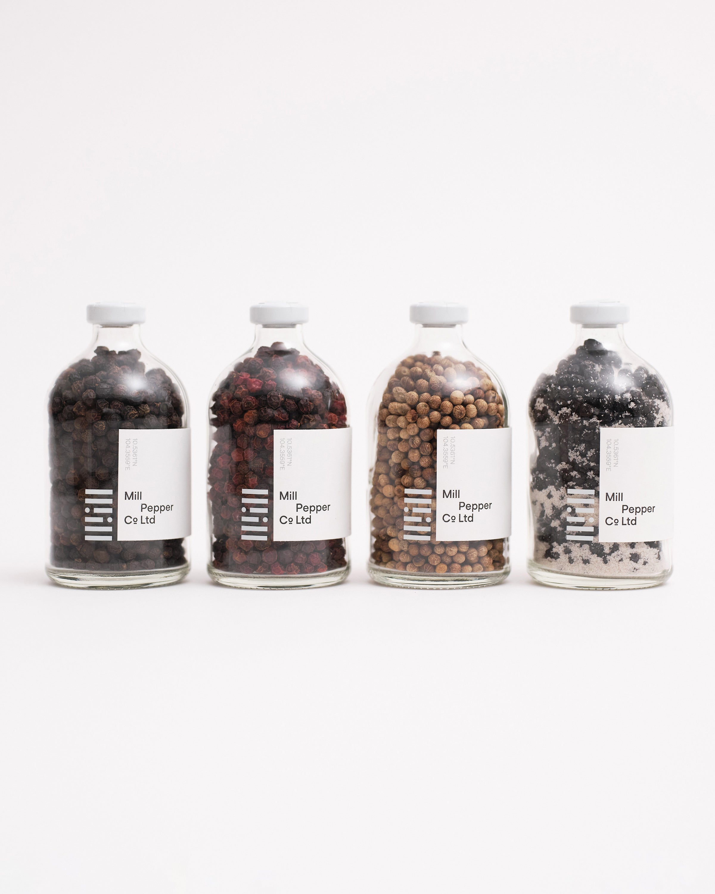 Black, Red, White and Green Mill Pepper Co. set.